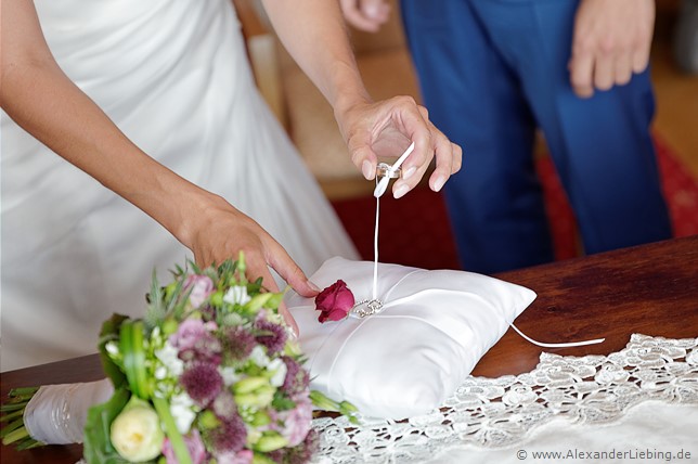 Hochzeit - standesamtliche Trauung Hochzeitsfotograf Standesamt Barleben / Robinien-Hof Gommern - behutsam nimmt die Braut den Ring von Kissen